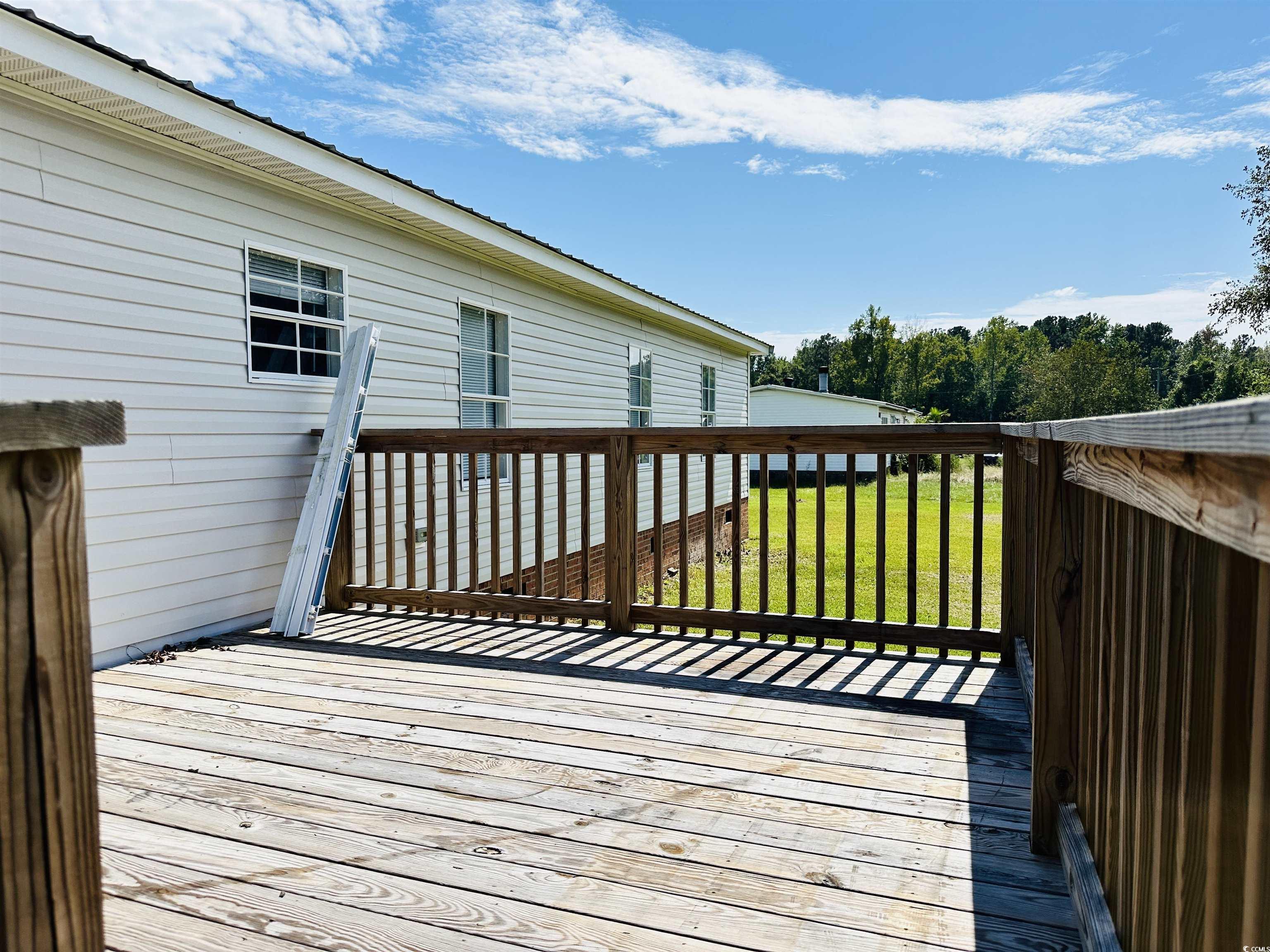 2067 Willow Creek Road Effingham, SC 29541 - Photo 11 of 40 Wooden terrace with a yard