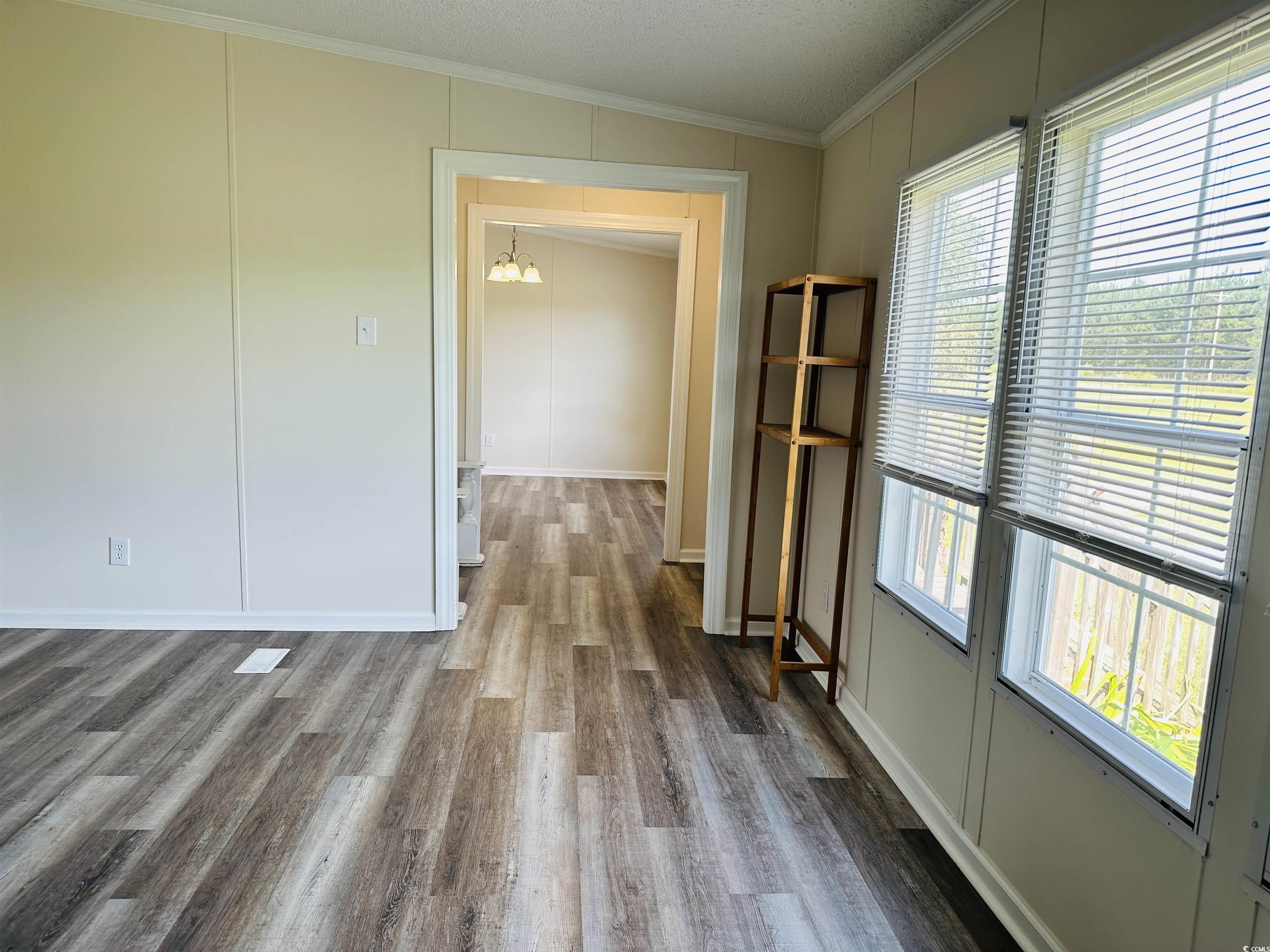 2067 Willow Creek Road Effingham, SC 29541 - Photo 27 of 40 Spare room with crown molding, wood finished floors, and a textured ceiling