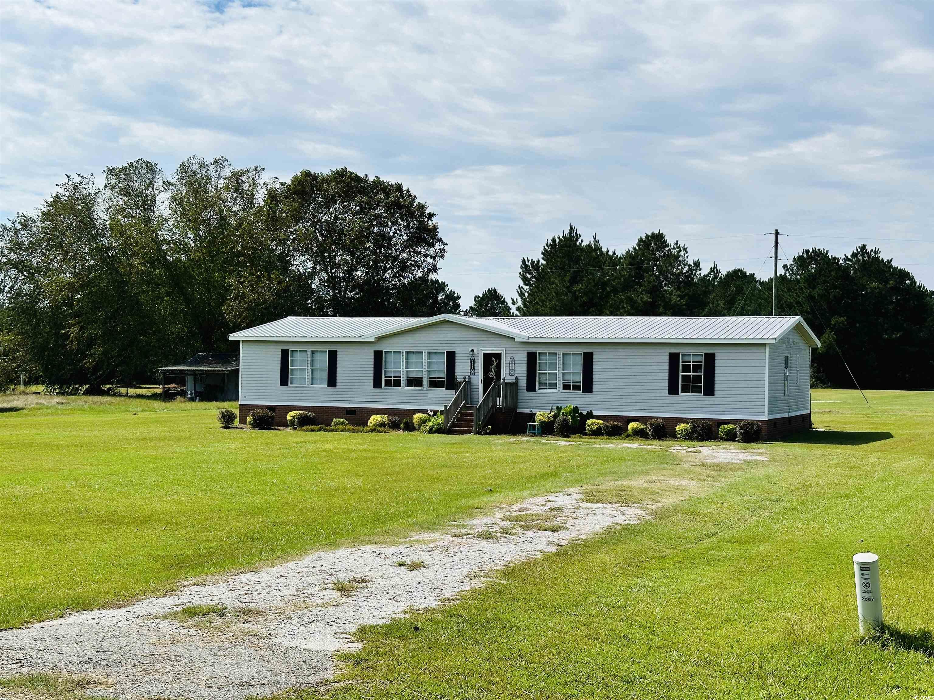 2067 Willow Creek Road Effingham, SC 29541 - Photo 3 of 40 Manufactured / mobile home featuring a front lawn