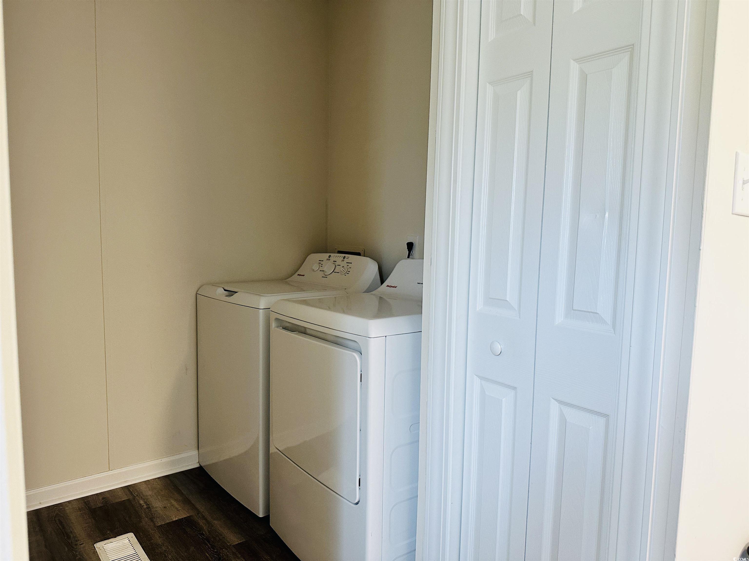 2067 Willow Creek Road Effingham, SC 29541 - Photo 35 of 40 Laundry area with dark wood-style floors and washing machine and clothes dryer