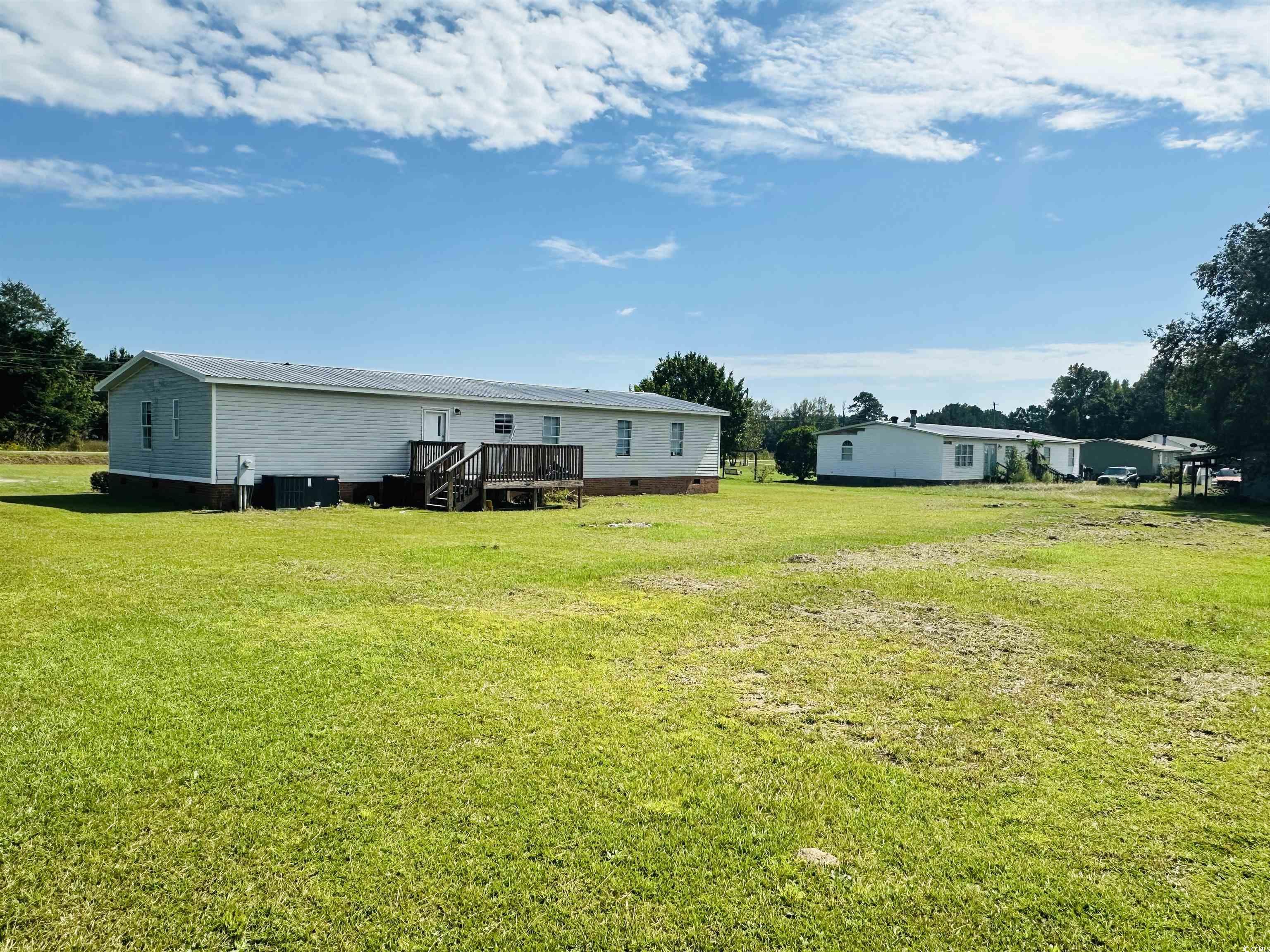 2067 Willow Creek Road Effingham, SC 29541 - Photo 7 of 40 Rear view of property with crawl space and a lawn