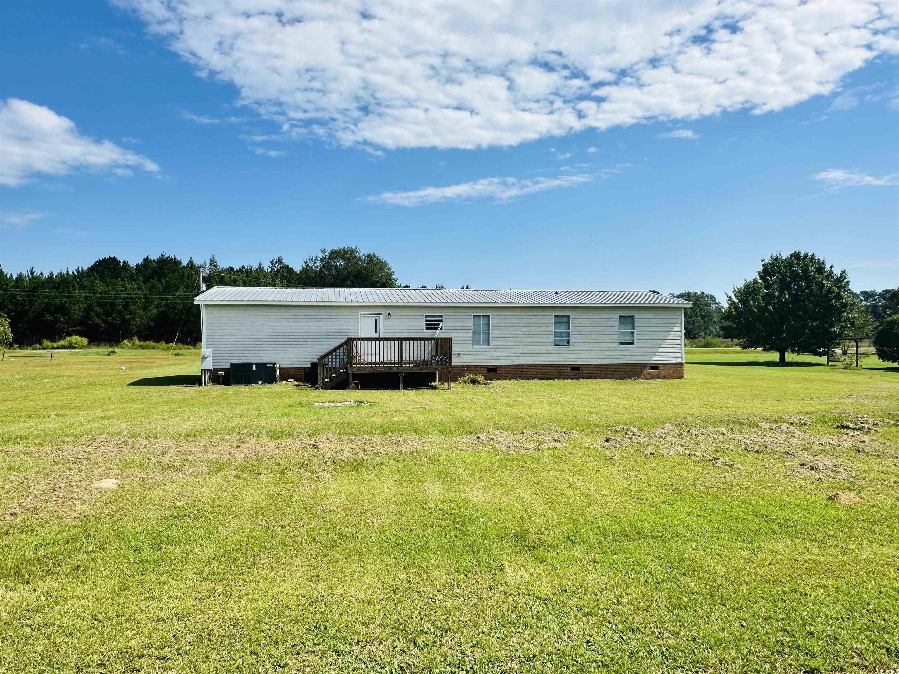2067 Willow Creek Road Effingham, SC 29541 - Photo 8 of 40 Back of property with crawl space, a yard, and a deck