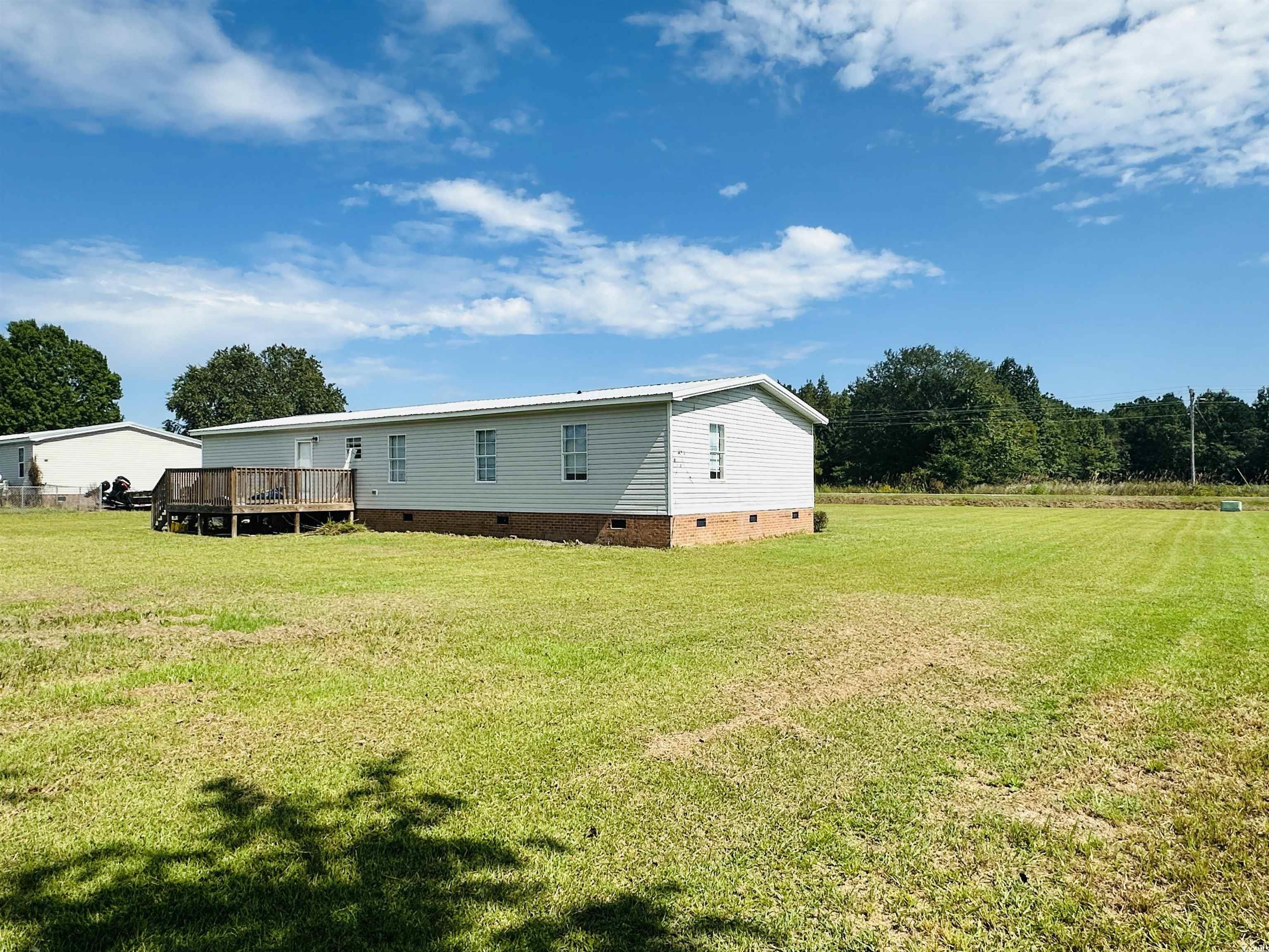 2067 Willow Creek Road Effingham, SC 29541 - Photo 10 of 40 Back of property with crawl space, a yard, and a deck