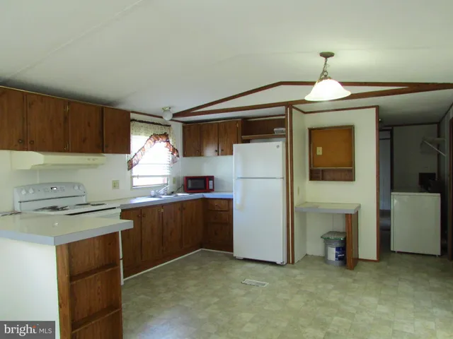 a kitchen with cabinets a sink and appliances