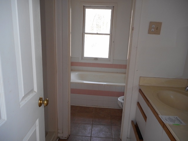 4201 Garth Road Charlottesville, VA 22901 - Photo 13 of 20 a bathroom with a bathtub and a window