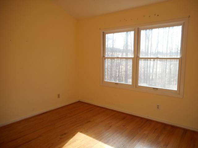 4201 Garth Road Charlottesville, VA 22901 - Photo 14 of 20 an empty room with wooden floor and windows