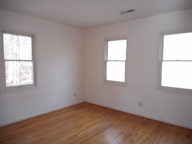 4201 Garth Road Charlottesville, VA 22901 - Photo 16 of 20 an empty room with wooden floor and windows