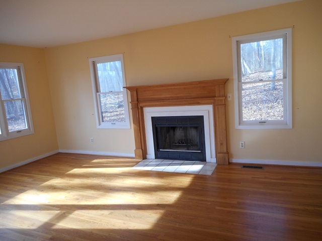 4201 Garth Road Charlottesville, VA 22901 - Photo 6 of 20 a view of an empty room with wooden floor fireplace and a window