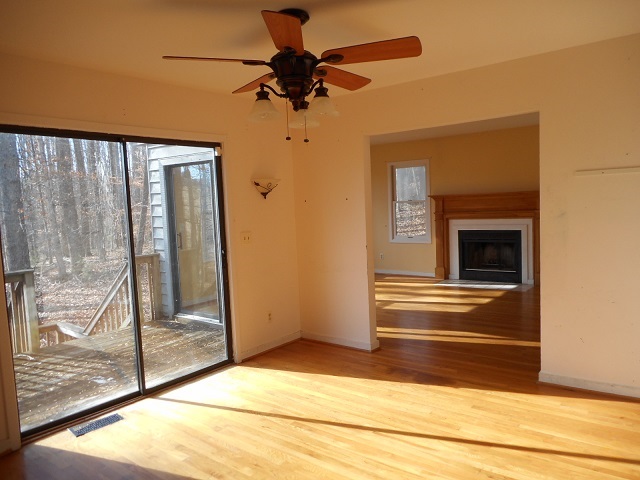 4201 Garth Road Charlottesville, VA 22901 - Photo 7 of 20 a view of room with wooden floor and a ceiling fan