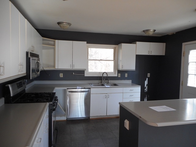 4201 Garth Road Charlottesville, VA 22901 - Photo 8 of 20 a kitchen with a sink stove and refrigerator