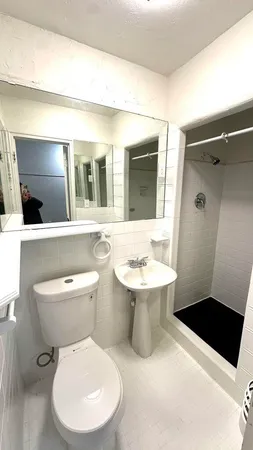 a white toilet sitting next to a bathroom sink