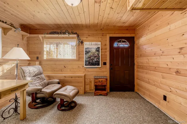 a view of a room with lots of wooden furniture and windows