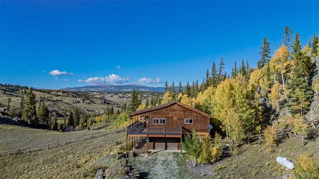 a view of a house with large trees