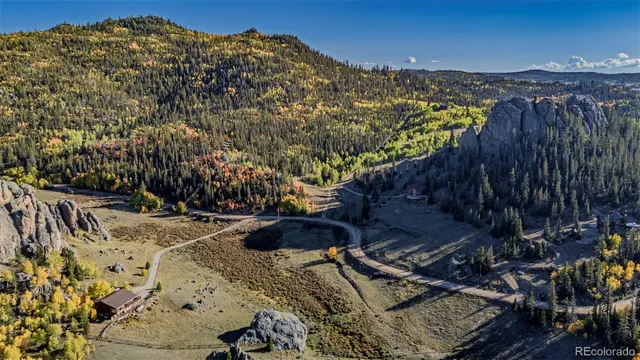 a view of a chairs and table on the roof deck