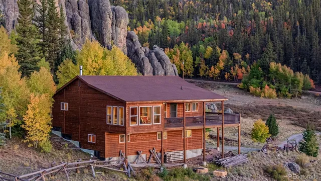 a view of a house with a yard wooden floor and a forest