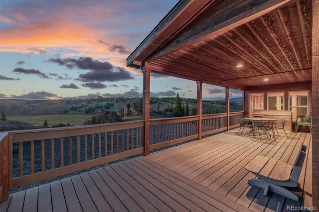 a view of balcony with wooden floor and fence