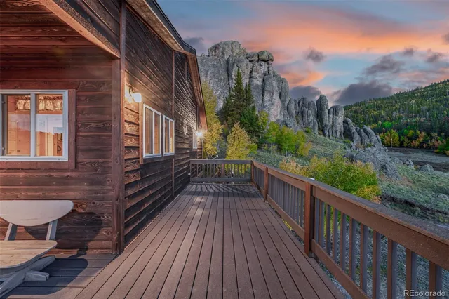 a view of a balcony with wooden floor and outdoor space