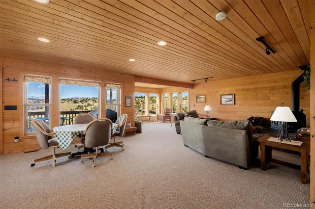 a living room with furniture city view and large windows