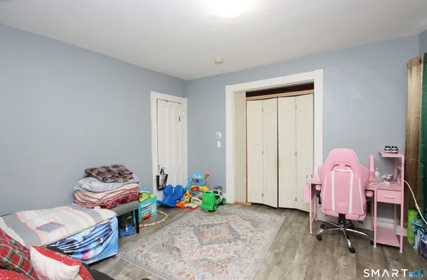 a bedroom with furniture and a window