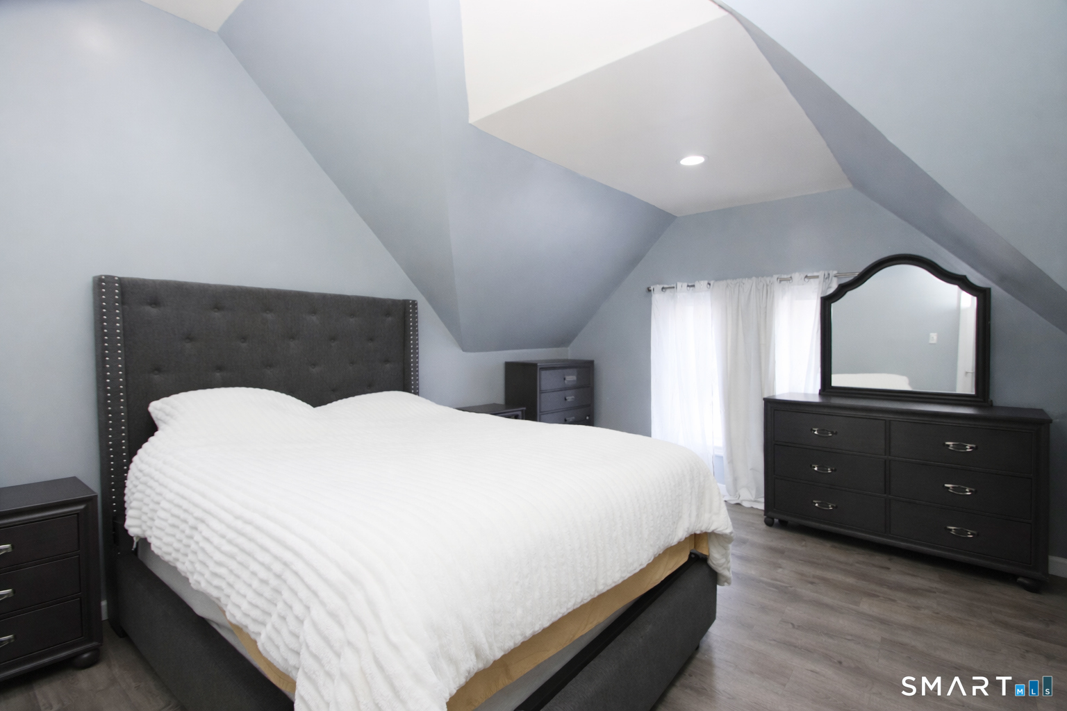 750 William Street Bridgeport, CT 06608 - Photo 18 of 35 a bedroom with a bed and a closet with mirror