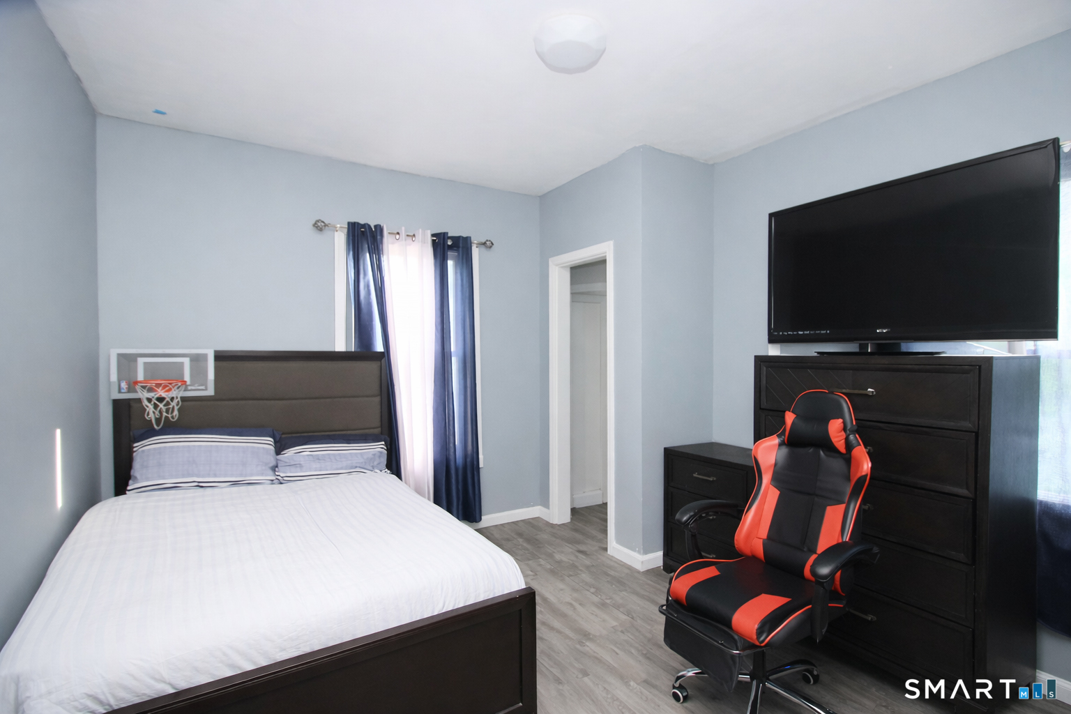 750 William Street Bridgeport, CT 06608 - Photo 19 of 35 a bedroom with a bed and a flat screen tv