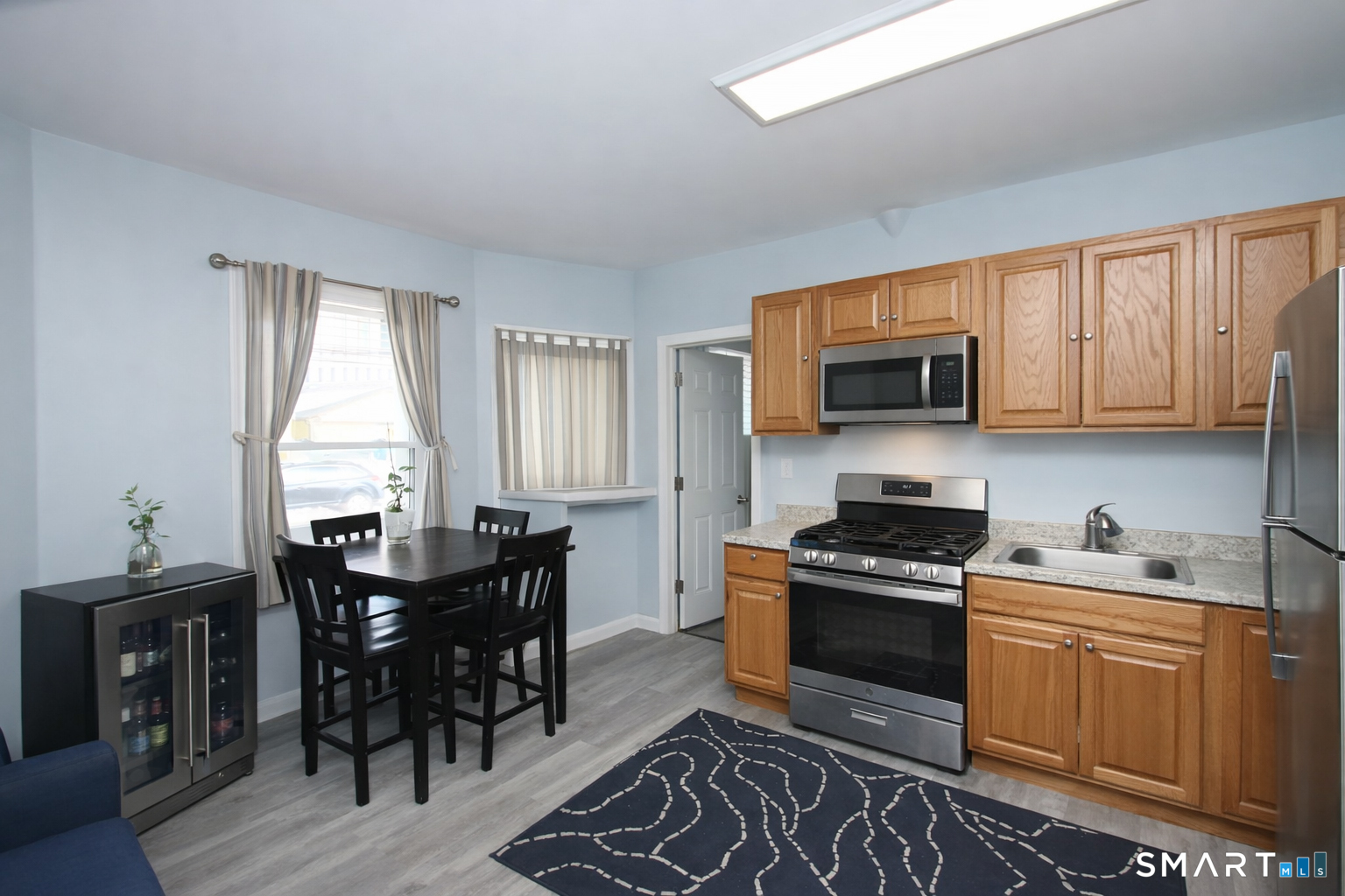 750 William Street Bridgeport, CT 06608 - Photo 8 of 35 a kitchen with stainless steel appliances a stove sink microwave and cabinets