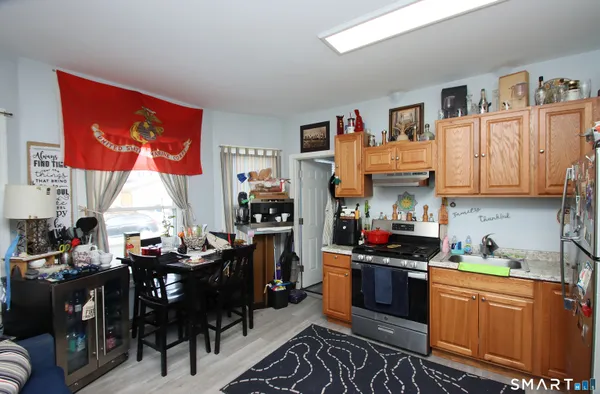 a kitchen with stainless steel appliances granite countertop a stove and cabinets
