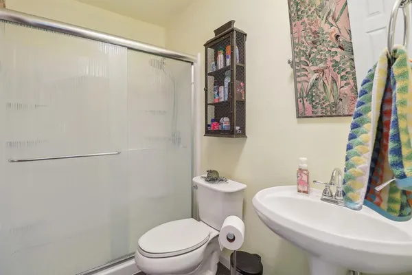 a white toilet sitting next to a bathroom sink