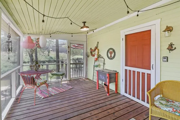 a view of a deck with wooden floor and furniture