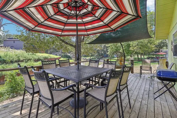 a view of an outside dining space with furniture and backyard