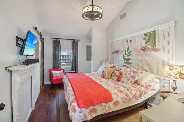 a bedroom with a bed and wooden floor