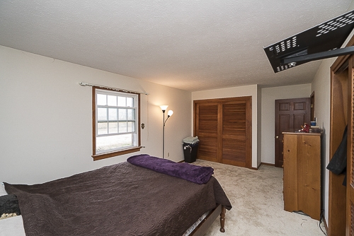 3629 Rockfish Road Grottoes, VA 24441 - Photo 13 of 32 a bedroom with a bed and wooden floor
