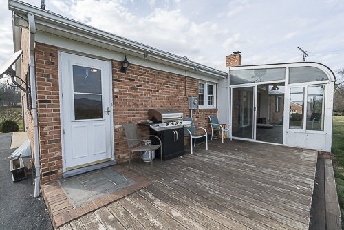 3629 Rockfish Road Grottoes, VA 24441 - Photo 29 of 32 a backyard of a house with barbeque oven table and chairs