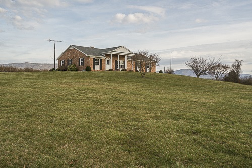 3629 Rockfish Road Grottoes, VA 24441 - Photo 7 of 32 a view of a white house next to a yard with wooden fence