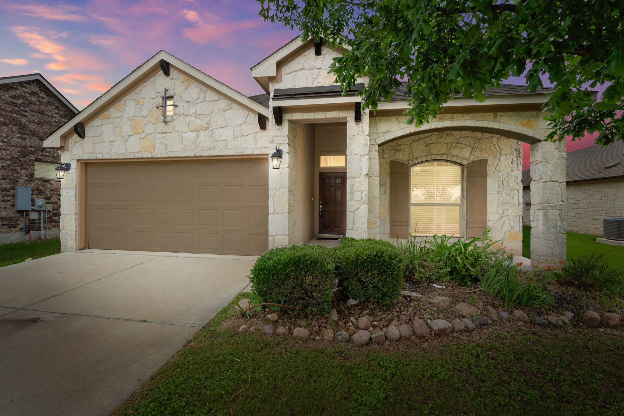 305 Longhorn Cavern Road Leander, TX 78641 - Photo 1 of 21 alk about a vibe! The exterior lighting and sunset sky show off just how stunning this home looks at twilight.