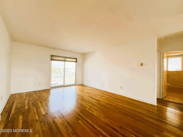 a view of an empty room and wooden floor