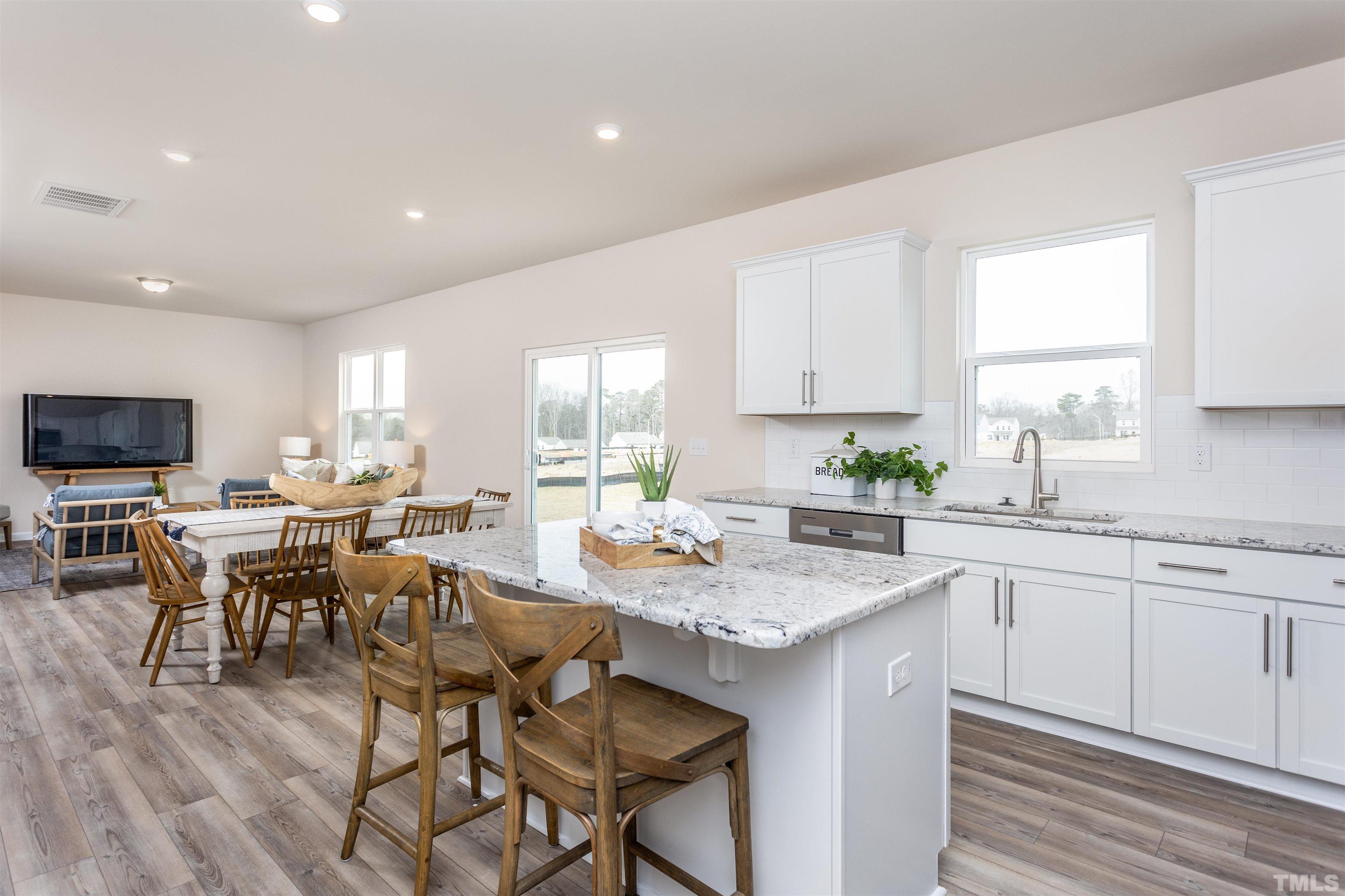 3469 Dragonfly River Raleigh, NC 27604 - Photo 14 of 26 a kitchen with a table and chairs in it