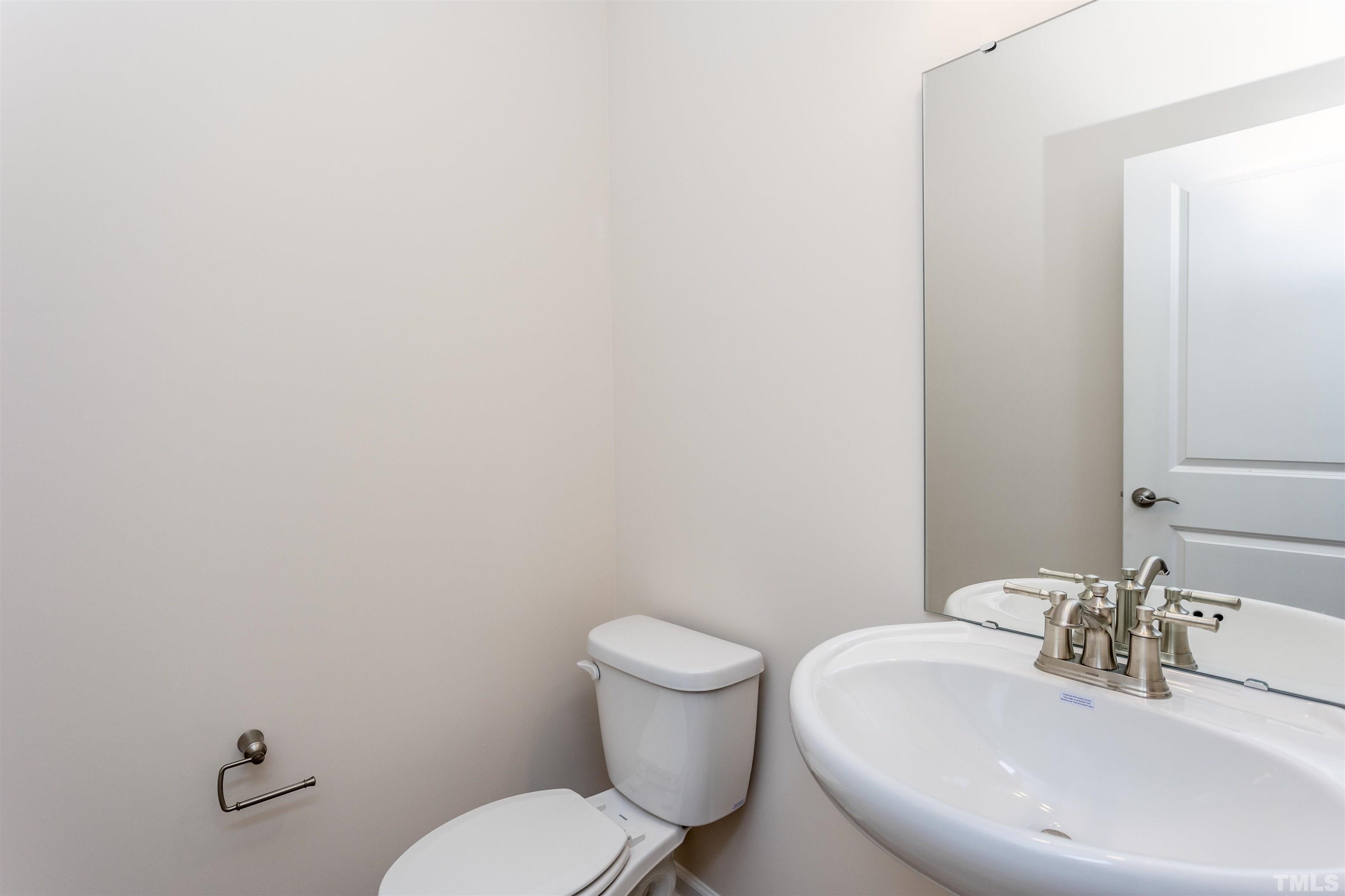 3469 Dragonfly River Raleigh, NC 27604 - Photo 18 of 26 a bathroom with a toilet and sink