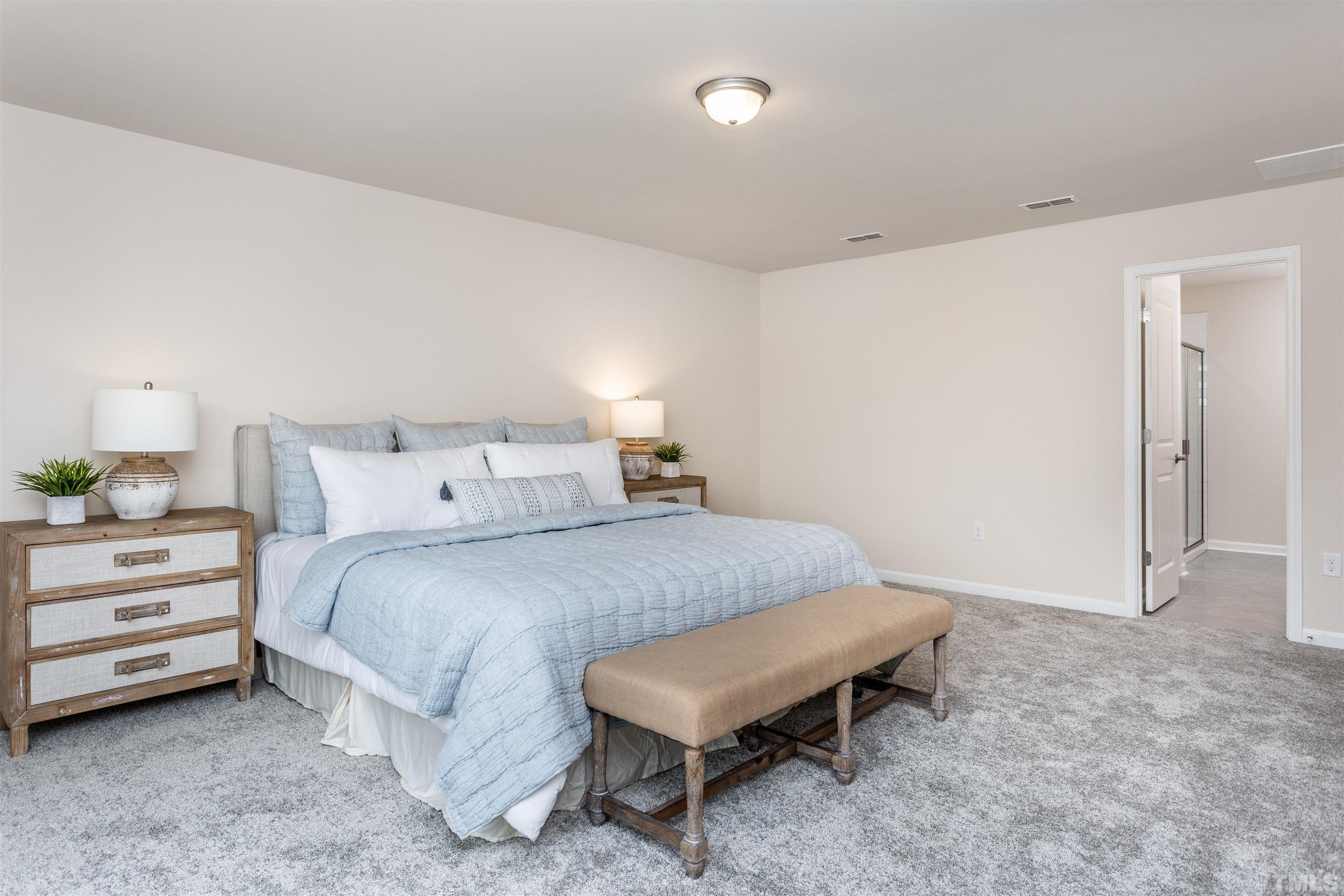 3469 Dragonfly River Raleigh, NC 27604 - Photo 21 of 26 a bedroom with a bed and a cabinets