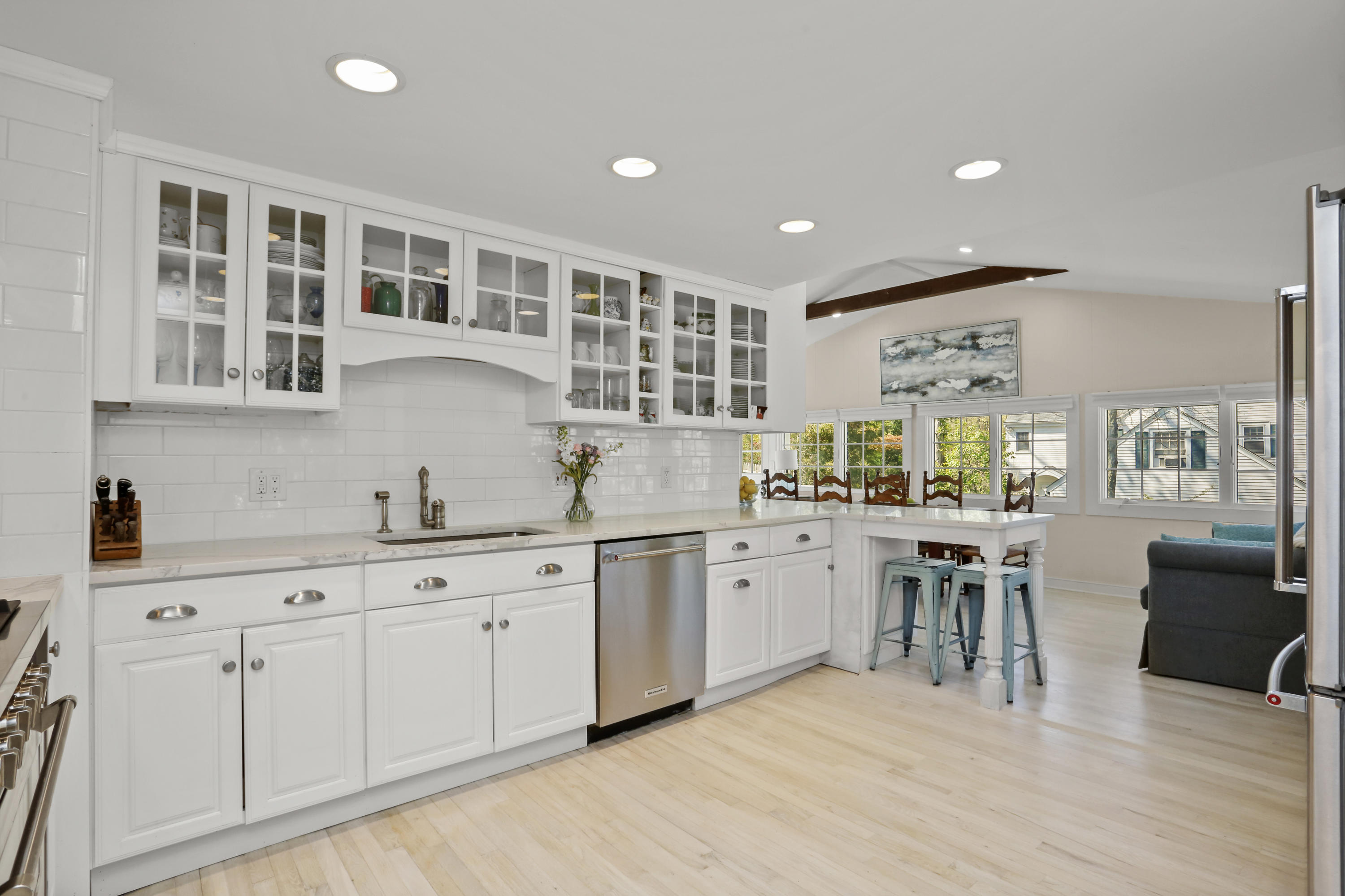 a kitchen with center island cabinets and wooden floor