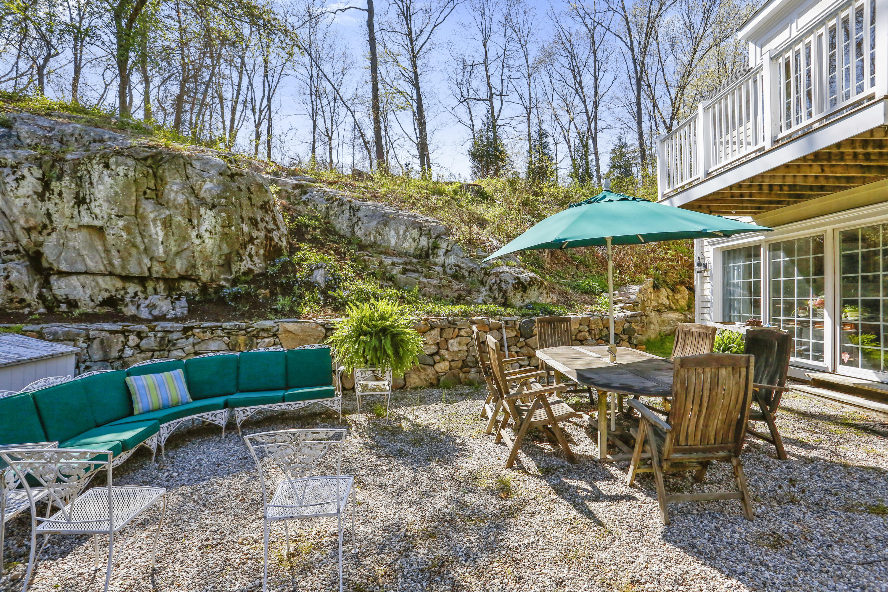 23 Fairmead Road Darien, CT 06820 - Photo 44 of 47 a view of a patio with a table and chairs under an umbrella