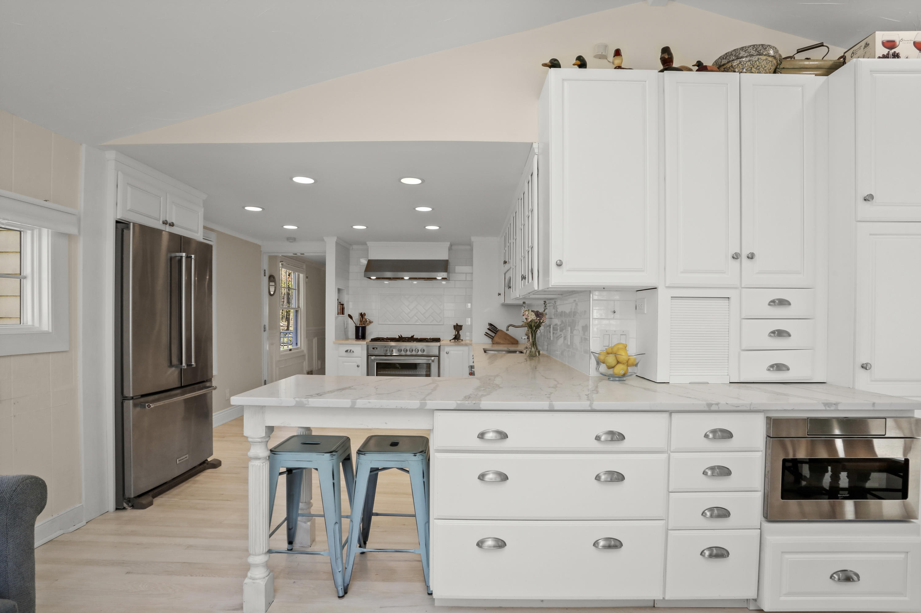 23 Fairmead Road Darien, CT 06820 - Photo 9 of 47 a kitchen with granite countertop white cabinets and refrigerator