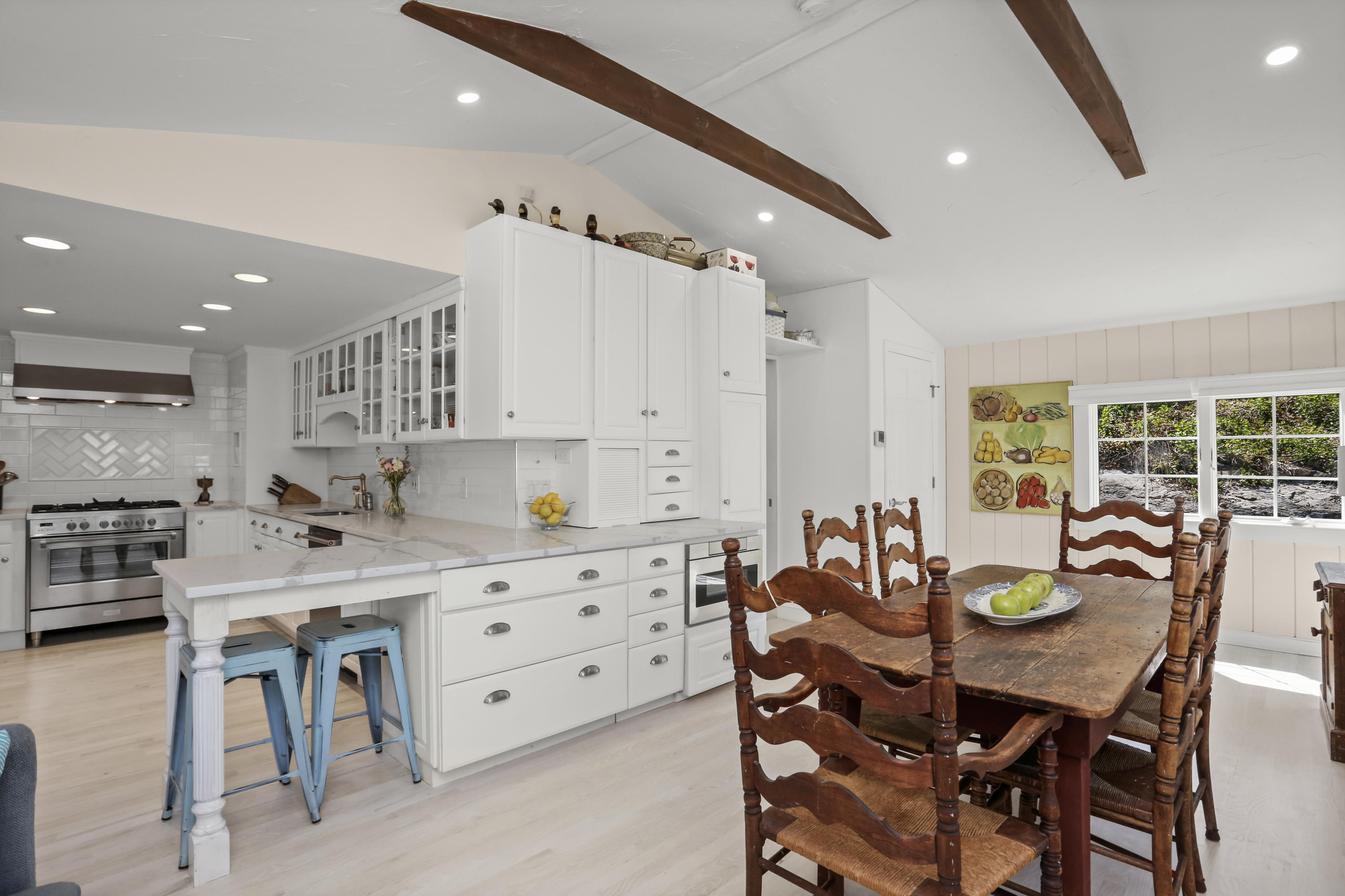 23 Fairmead Road Darien, CT 06820 - Photo 10 of 47 a kitchen with stainless steel appliances kitchen island granite countertop a table and chairs in it