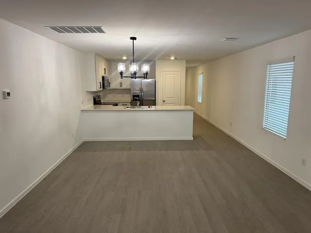 a large white kitchen with a sink and dishwasher