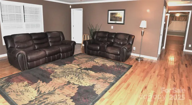 a living room with a couch wooden floor and a rug