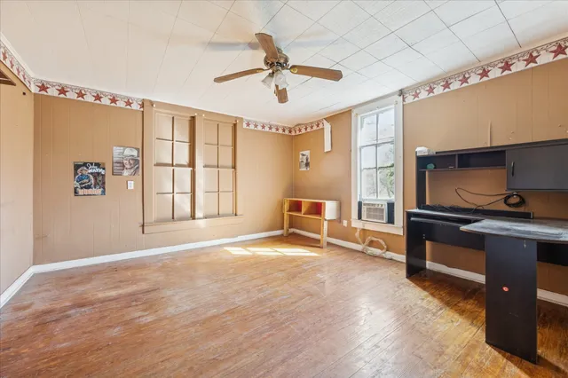 a view of an empty room with a fireplace and a window