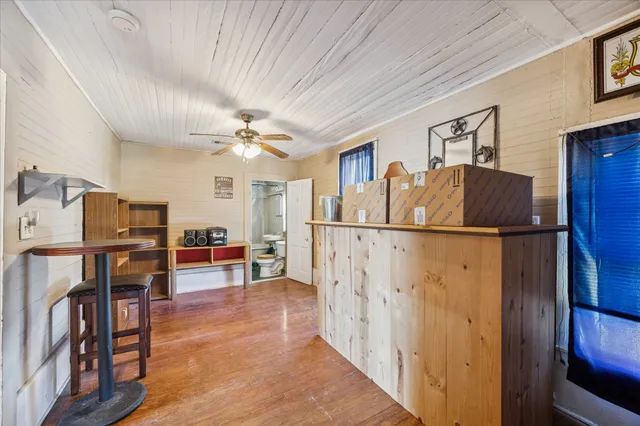 a view of kitchen with furniture and wooden floor