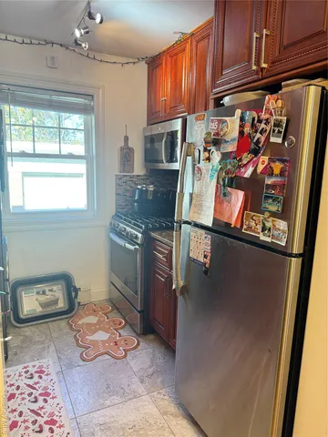 a kitchen with granite countertop a stove a sink and a microwave