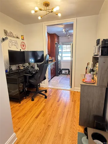 a kitchen with a sink cabinets and wooden floor