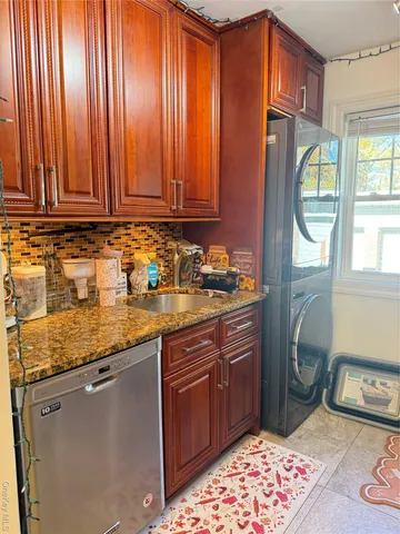 a utility room with sink dryer and washer